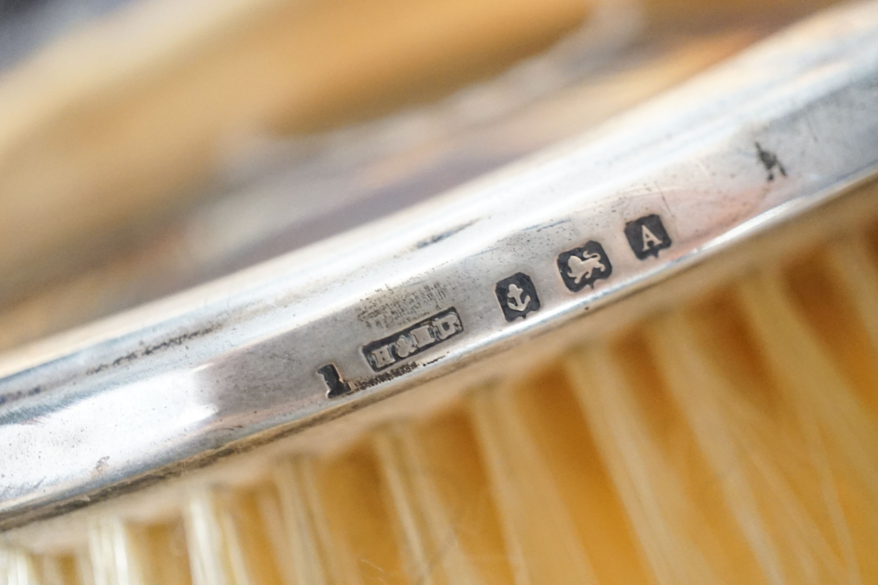 A 1920's cased tortoiseshell and silver mounted mirror and brush set.